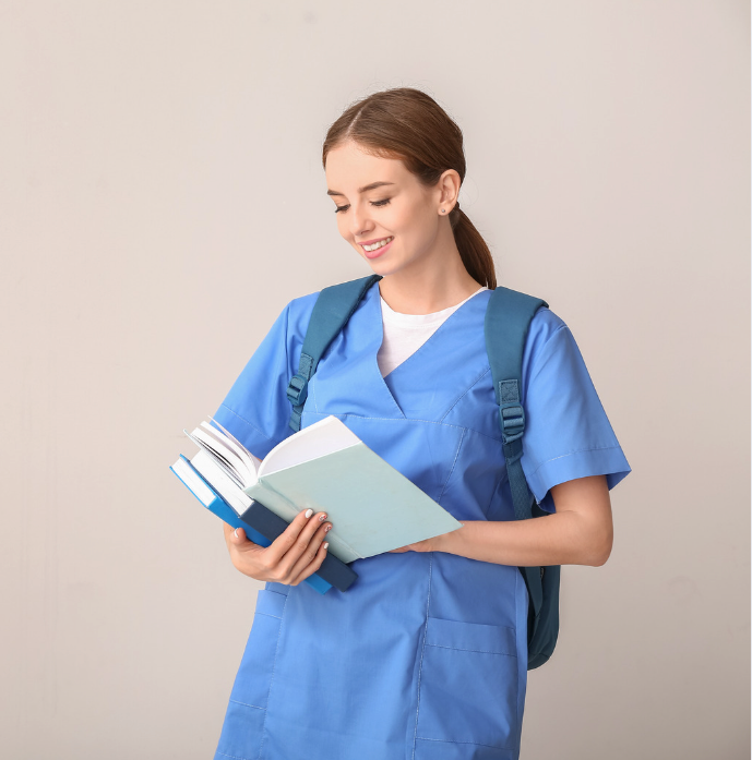 Nursing student using a planner and laptop to organize study schedule efficiently
